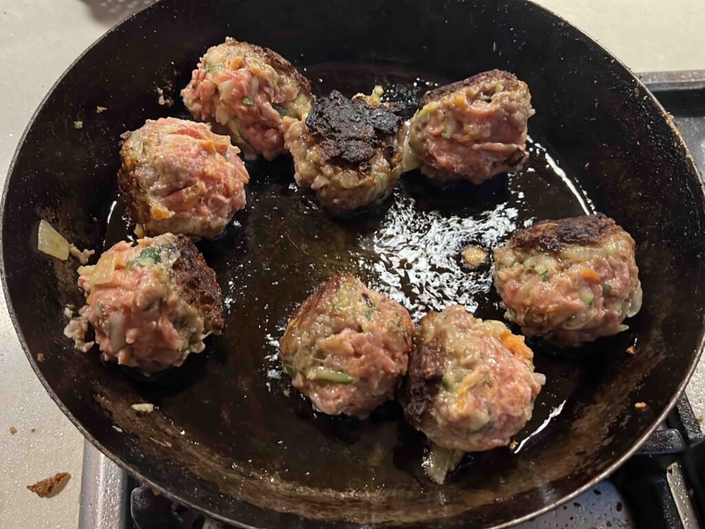 Sausage Stuffing Balls cooking in the frying pan