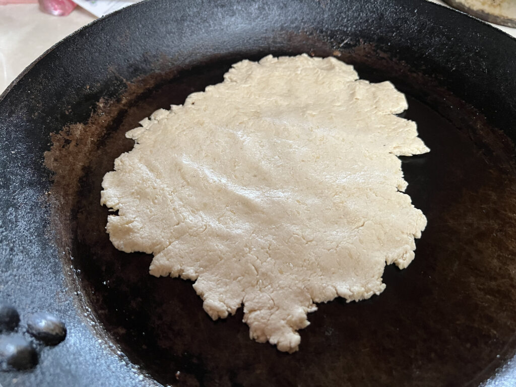 Dough flattened in a pan