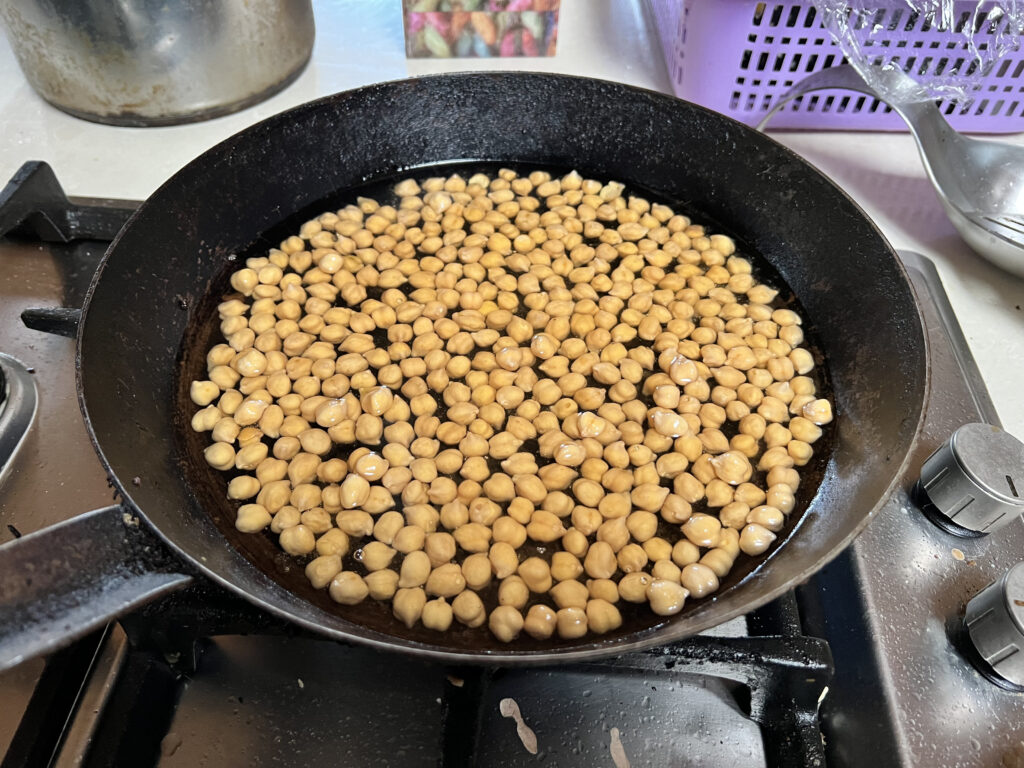 Chickpeas cooking in frying pan