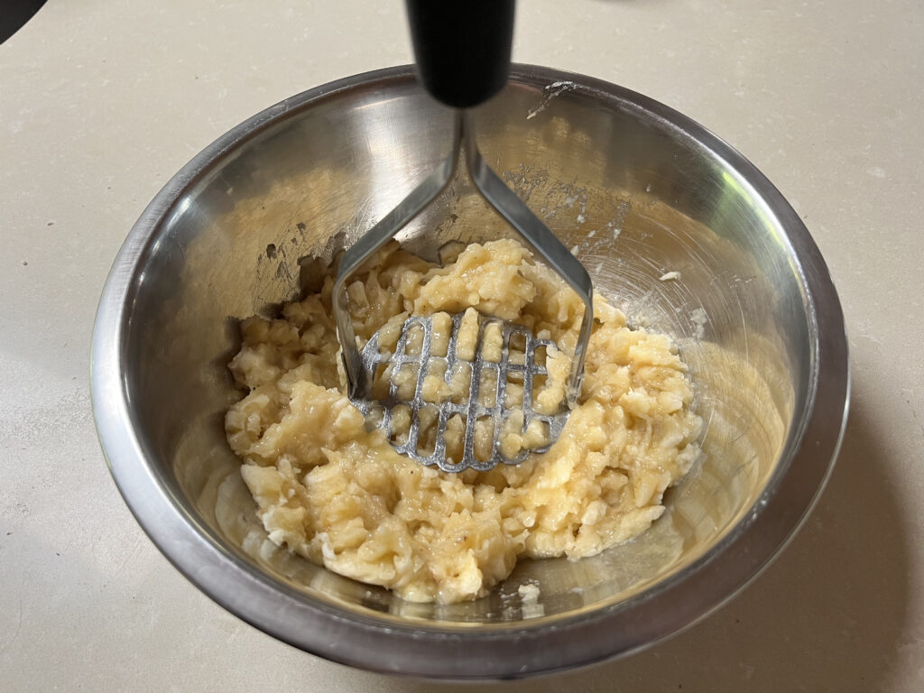 
Using a potato masher to mash the banana's 