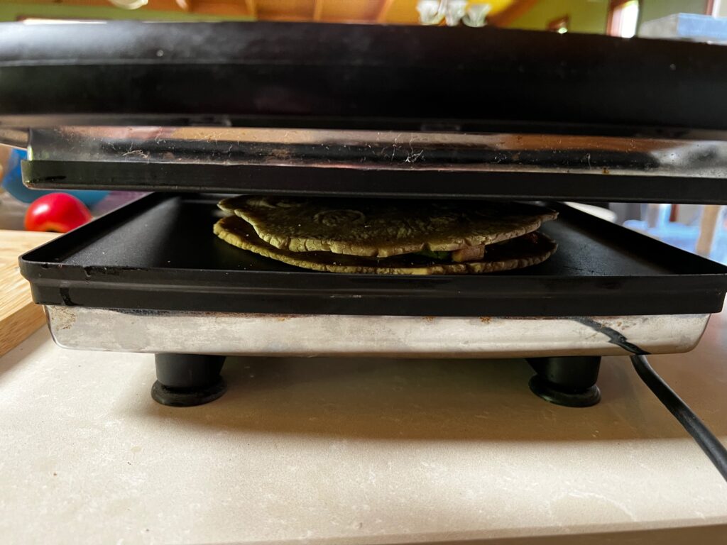 Toastie cooking in the sandwich press