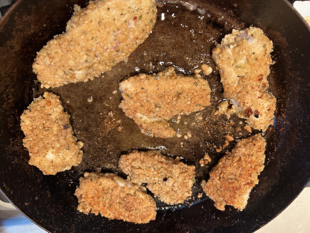 Crumbed Chicken flipped over to cook